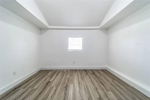 6305 Pine St, Rowlett, TX 75089 - empty room featuring wood finished floors, baseboards, and lofted ceiling