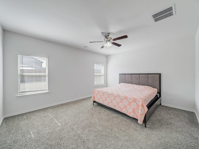 bedroom featuring carpet floors, visible vents, and baseboards