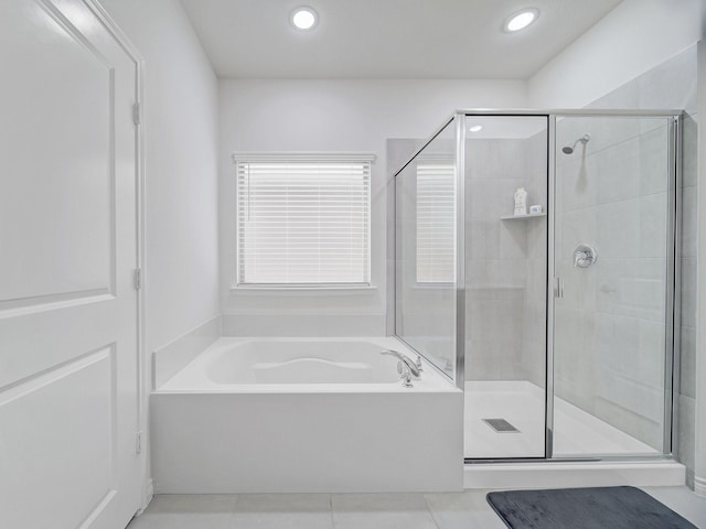 full bath with a stall shower, recessed lighting, a bath, and tile patterned floors