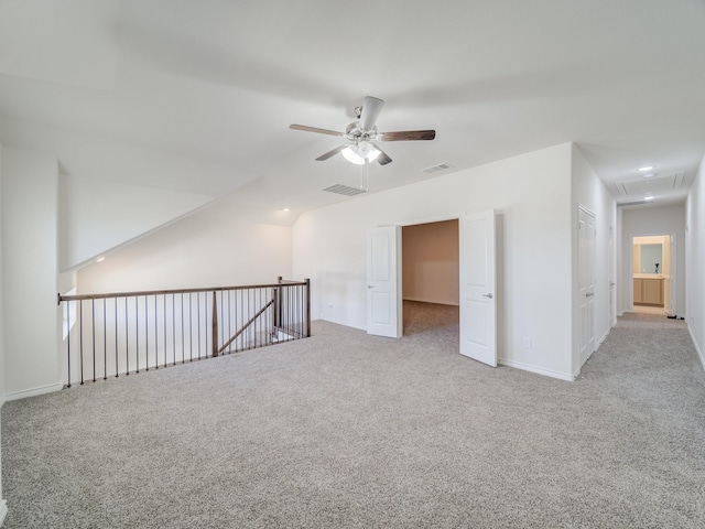 bonus room with attic access, visible vents, ceiling fan, and carpet flooring