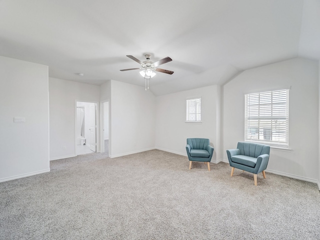 unfurnished room featuring lofted ceiling, ceiling fan, carpet flooring, and baseboards