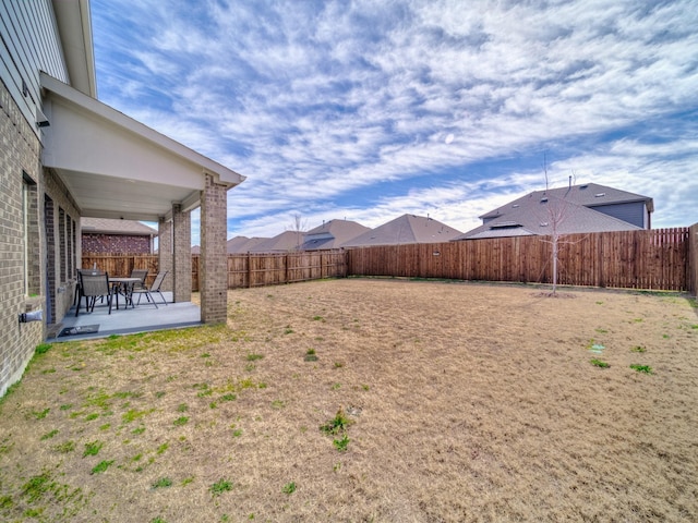 view of yard with a patio area and a fenced backyard