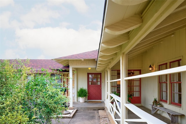 property entrance with roof with shingles