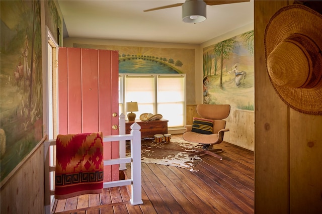 living area with ceiling fan and hardwood / wood-style floors