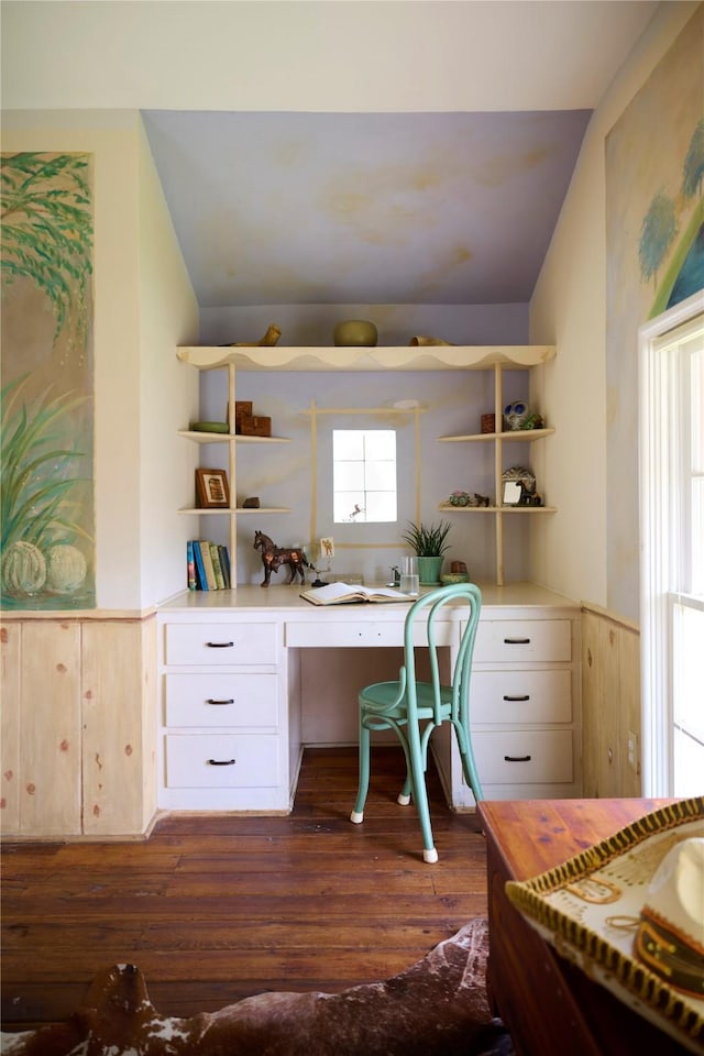 office featuring dark wood-type flooring, vaulted ceiling, and built in desk