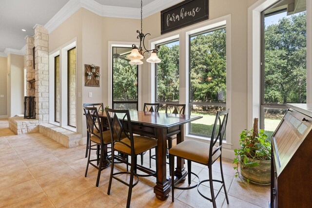 dining room featuring crown molding and light tile patterned flooring
