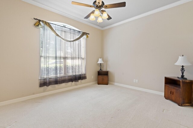 carpeted empty room with ornamental molding, ceiling fan, and baseboards