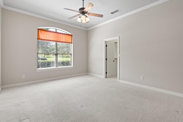 unfurnished room with ornamental molding, carpet flooring, ceiling fan, and baseboards