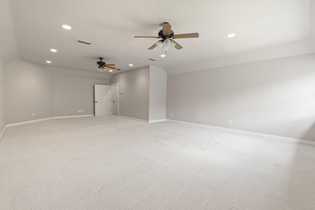 empty room with recessed lighting, a ceiling fan, baseboards, light carpet, and vaulted ceiling