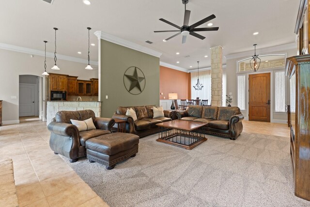 living room with light tile patterned flooring, crown molding, a ceiling fan, recessed lighting, and decorative columns