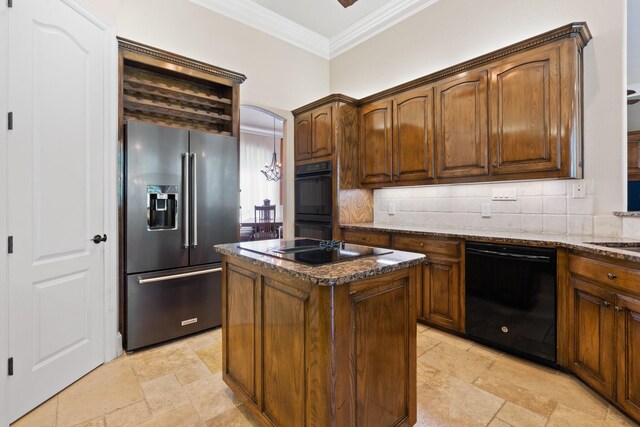 kitchen featuring black appliances, crown molding, decorative backsplash, a kitchen island, and dark stone countertops
