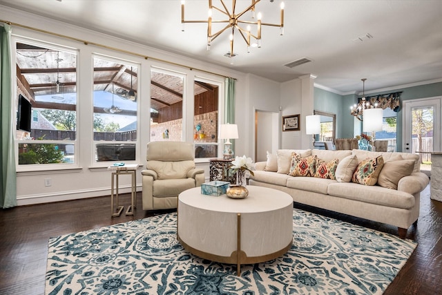 living room with visible vents, ornamental molding, wood finished floors, a chandelier, and baseboards