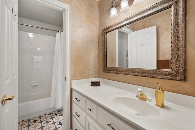 bathroom with tile patterned floors, shower / bath combo, a textured wall, and vanity