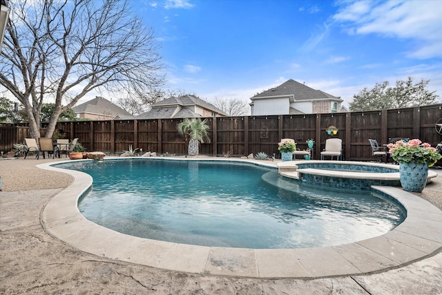 view of pool featuring a fenced backyard, a pool with connected hot tub, and a patio