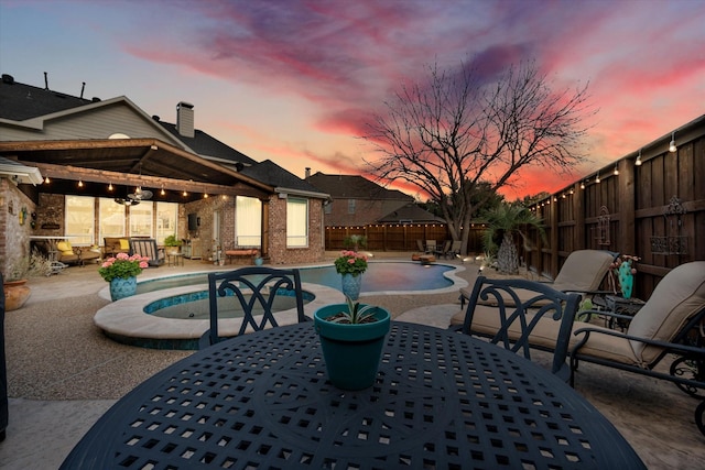 view of patio with a fenced in pool, outdoor dining area, and a fenced backyard