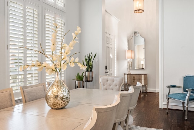 dining space with wood finished floors and baseboards