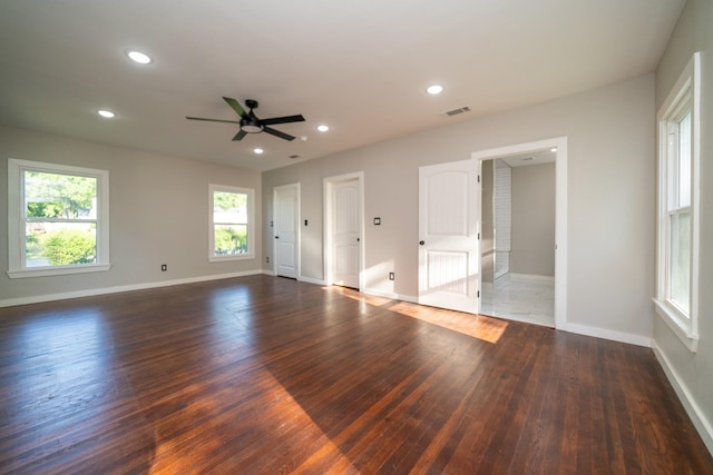 empty room featuring wood finished floors, visible vents, and recessed lighting