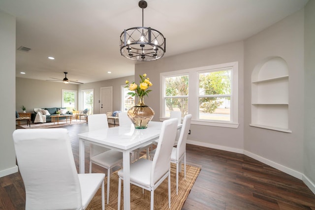 dining space with a healthy amount of sunlight, baseboards, and built in features