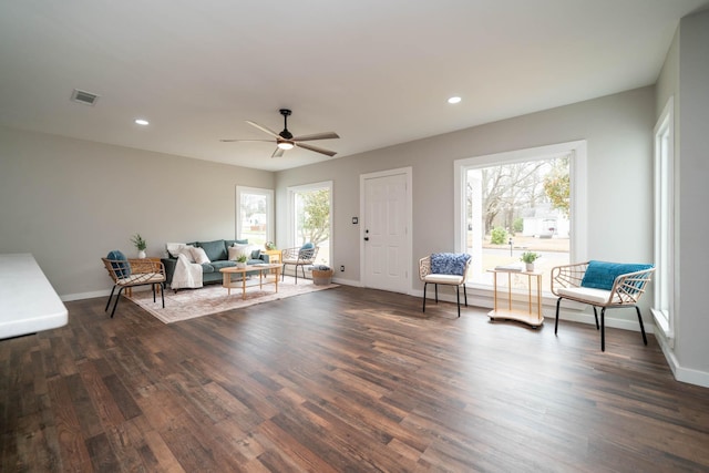 living area featuring baseboards, visible vents, dark wood finished floors, and recessed lighting