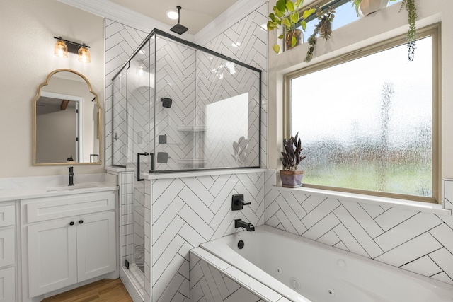 full bathroom with a jetted tub, a shower stall, and vanity