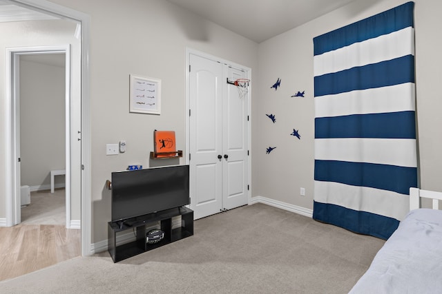 bedroom with a closet, carpet flooring, and baseboards