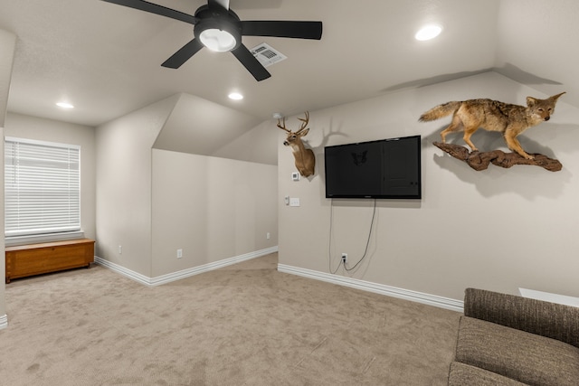 interior space featuring visible vents, vaulted ceiling, and carpet flooring