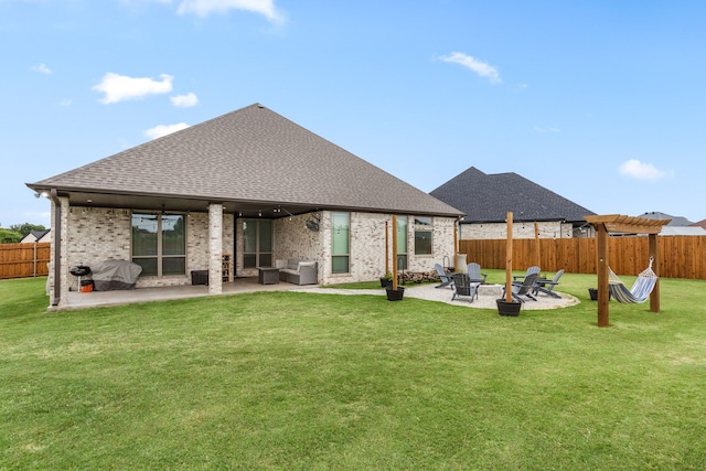 back of house featuring a yard, fence private yard, roof with shingles, and a patio