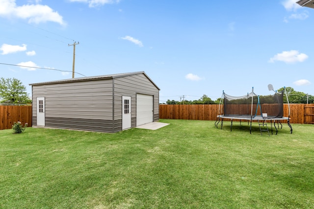 view of yard featuring a fenced backyard, a trampoline, and an outdoor structure