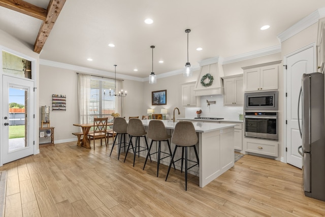 kitchen with light wood-style flooring, a kitchen breakfast bar, custom exhaust hood, stainless steel appliances, and light countertops