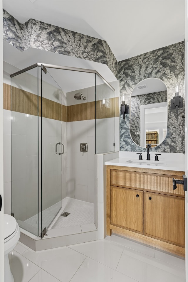 full bathroom featuring toilet, a stall shower, vanity, tile patterned flooring, and wallpapered walls