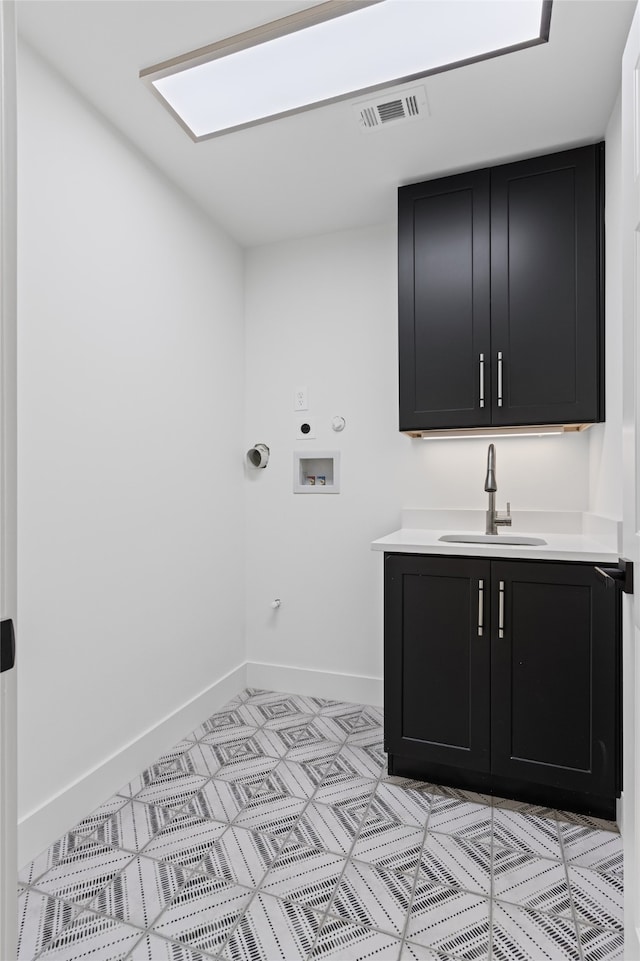 laundry area with cabinet space, visible vents, hookup for a gas dryer, hookup for a washing machine, and a sink