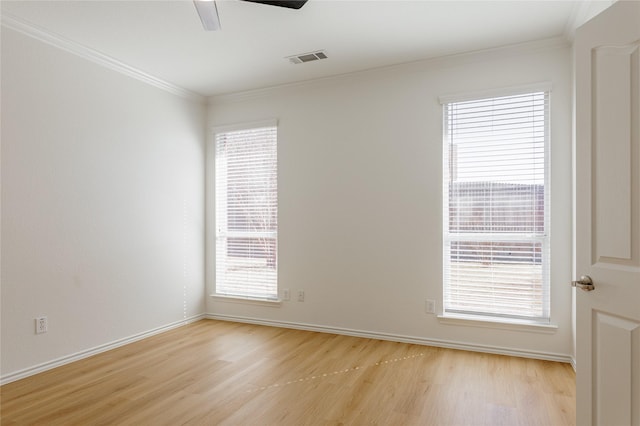 unfurnished room featuring light wood-style floors, visible vents, ornamental molding, and a ceiling fan