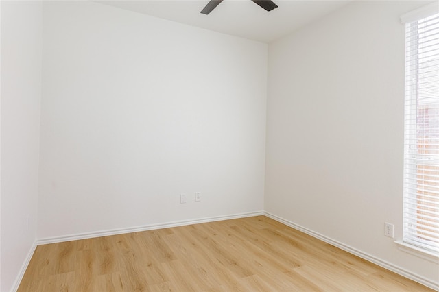 unfurnished room featuring a ceiling fan, light wood-type flooring, and baseboards