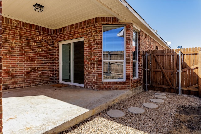 view of patio with fence and a gate