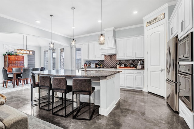 kitchen featuring tasteful backsplash, concrete floors, appliances with stainless steel finishes, and premium range hood