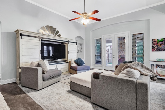 living room with baseboards, arched walkways, ornamental molding, concrete flooring, and french doors