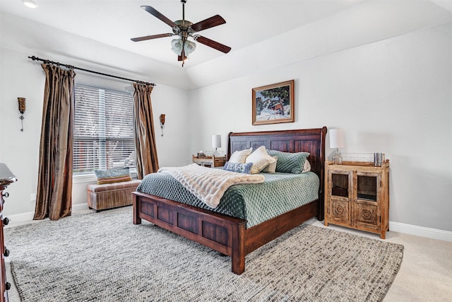 carpeted bedroom featuring baseboards, vaulted ceiling, and a ceiling fan