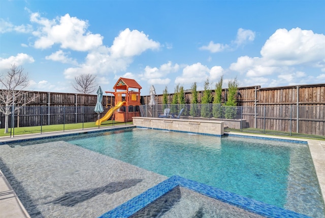 view of pool featuring a playground, a fenced backyard, and a fenced in pool