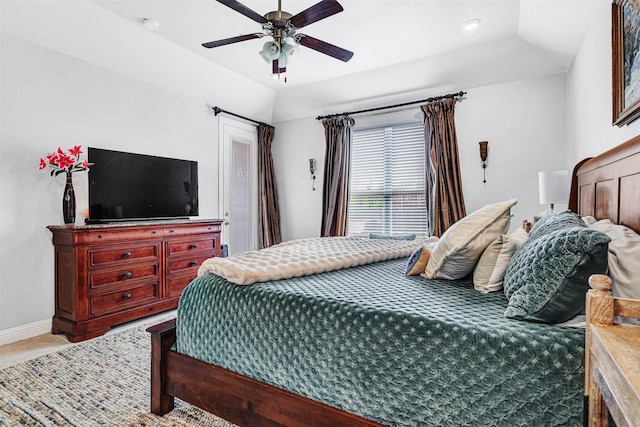 bedroom with carpet floors, vaulted ceiling, baseboards, and ceiling fan