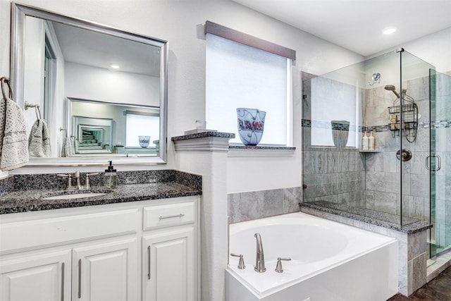 full bathroom with recessed lighting, a shower stall, a bath, and vanity