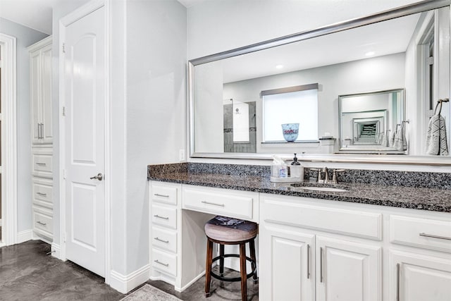 bathroom featuring walk in shower, concrete flooring, and vanity