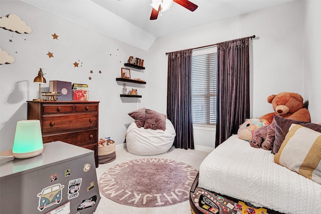 carpeted bedroom featuring lofted ceiling, baseboards, and a ceiling fan