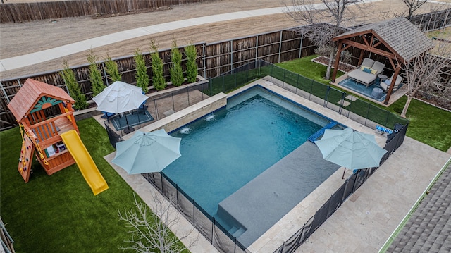 view of swimming pool with a playground, a fenced backyard, a yard, a gazebo, and a fenced in pool