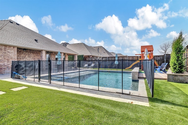 view of pool featuring playground community, a lawn, and fence