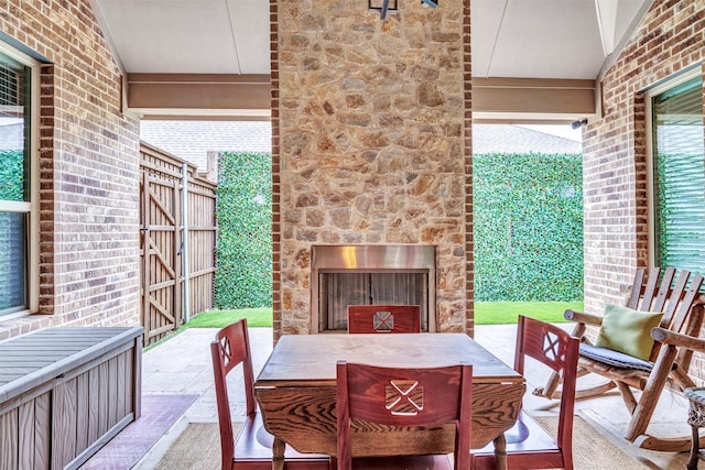 view of patio / terrace featuring exterior fireplace and outdoor dining space