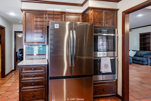 kitchen featuring stainless steel appliances, recessed lighting, tasteful backsplash, light countertops, and light tile patterned flooring