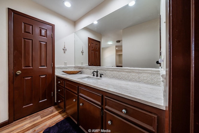 bathroom with wood finished floors and vanity