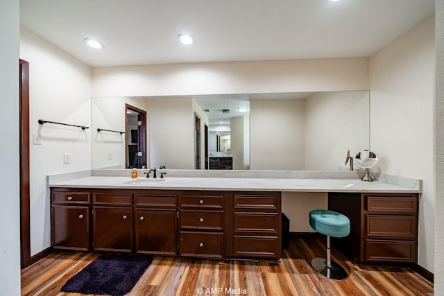 bathroom with wood finished floors and vanity