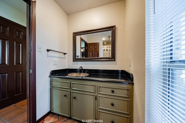 bathroom featuring tile patterned flooring, vanity, and baseboards