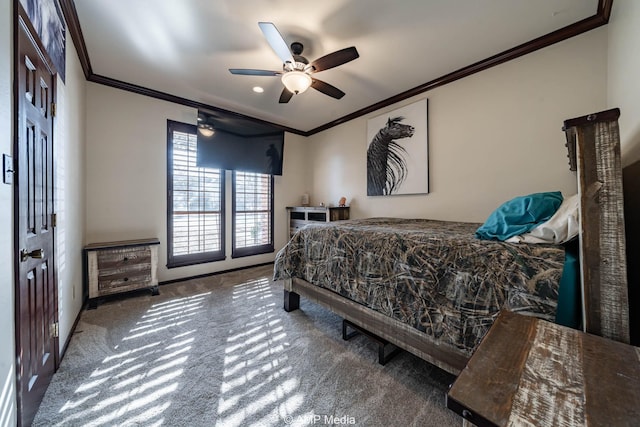 carpeted bedroom with ornamental molding, baseboards, and a ceiling fan